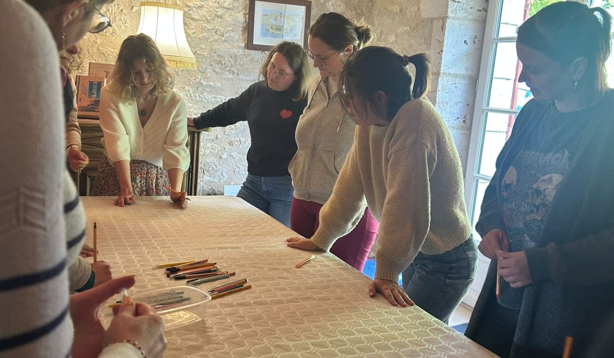 Atelier d'écriture ludique se déroulant lors d'une retraite littéraire. Dix personnes autour d'une table.